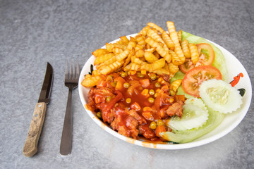 Asian Hainanese chicken chop with gravy and potato fries