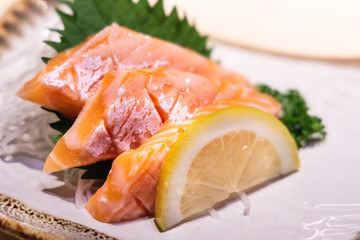 Fresh salmon belly sashimi served on plated in Japanese restaurant