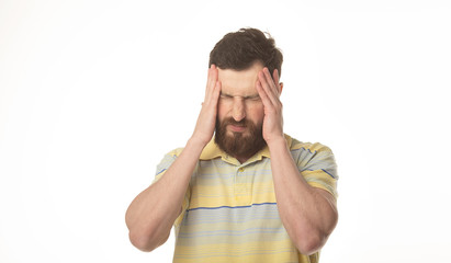 Fototapeta premium Feeling terrible headache. Portrait of bearded man is standing and touching his temples while suffering from pain. 