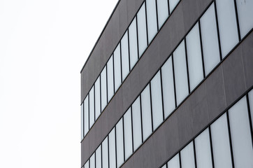 many empty windows of a gray concrete building