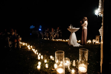 woman emcee perfoming speech for evening wedding ceremony in the garden