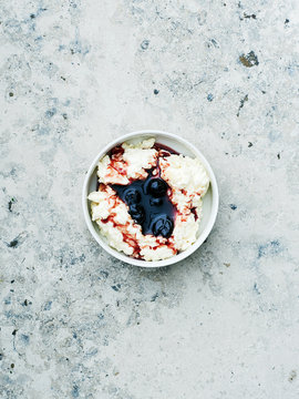 Rice dessert with cherry sauce on stone background