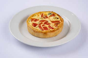 Broccoli cheddar mini savory pies on white plate. Delicious appetizers, snack, tapas. Flat lay.