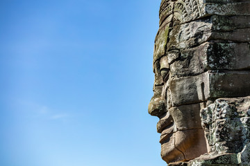 Fototapeta na wymiar Beautiful face sculptures at the famous Bayon temple in the Angkor Thom temple complex, Siem Reap, Cambodia