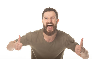 Portrait of a handsome young bearded man laughing