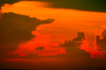 colorful of sunrise on silhouette cloud sky fishing boat and on sea island