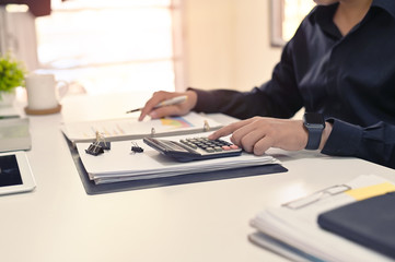 Finance concept, Businessman calculate on table.