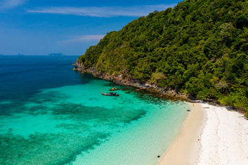 Aerial drone view of a beautiful deserted tropical island with lush foliage and a sandy beach (Ahtet Le Ywe Island, Mergui Archipelago, Myanmar)