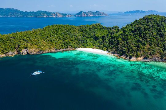 Aerial drone view of a beautiful deserted tropical island with lush foliage and a sandy beach (Ahtet Le Ywe Island, Mergui Archipelago, Myanmar)