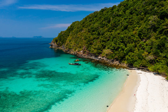 Aerial drone view of a beautiful deserted tropical island with lush foliage and a sandy beach (Ahtet Le Ywe Island, Mergui Archipelago, Myanmar)