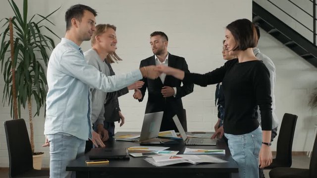 Great job! Successful business team is clapping their hands in modern office coworking, celebrating the performance of new product applause together success