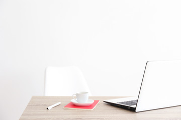 workspace with modern laptop at sunrise