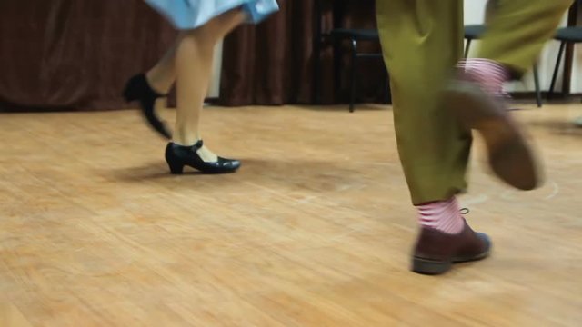 Dancing legs close up. Dancers perform lindy hop dance at the swing festival.