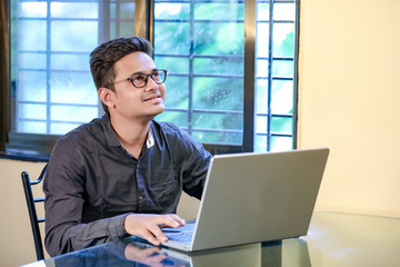 Fototapeta premium Young indian man with laptop