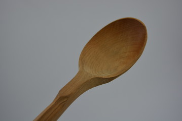 Kitchen brown spoon made of natural wood, carved products, woodworking industry.