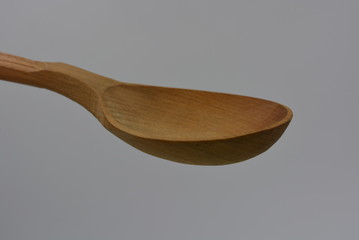 Kitchen brown spoon made of natural wood, carved products, woodworking industry.