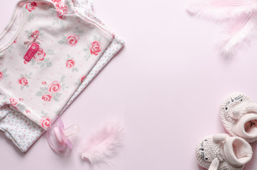 Baby pink accessories on pink background.