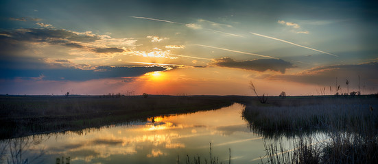 Sunset on the river in the Astrakhan region. Irrigation system for agriculture