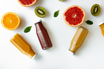 Healthy background with different juices and fruits on white desk