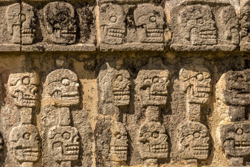 Close-up view of carved skulls in a Mayan temple in Chichen Itza, Mexico