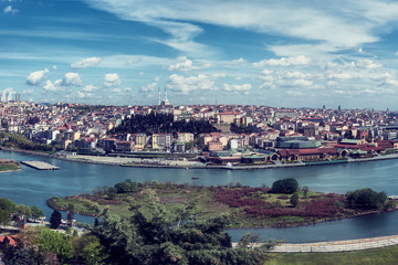 Fototapeta premium Panoramic view of Istanbul from Pierre Loti Hill (Tepesi). Beautiful day time cityscape with Golden Horn bay, buildings and blue sky with clouds, Turkey. Travel background for wallpaper or guide book