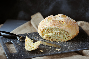 white bread, cut piece of bread, bread crumbs and bread knife