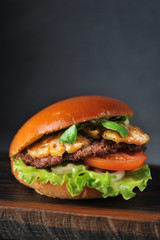 hamburger with cutlet, tomato and pineapple