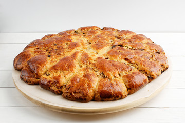Homemade bread with raisins and cranberries on white wooden table