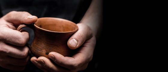 Hands of potter making clay pot, closeup photo