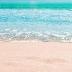 Soft wave of blue ocean on sandy beach. Summer Background. Copyspace