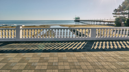 view from the promenade to the pier on the sandy beach and the sea in .