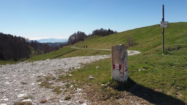European path E5 with stone cippus and panorama of the mountains