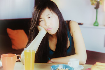 Unhappy sad Chinese woman tired at home closeup