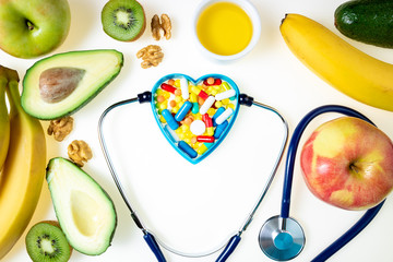 Stethoscope, pharmaceutical medicine pills, tablets, capsules and healthy food with good fat omega...