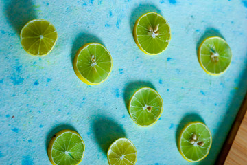 fresh yellow and green lemon on blue background