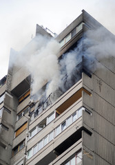 Fire and smoke blaze from apartment in a high building
