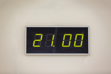 Black digital clock on a white background showing time 21.00