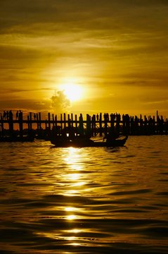 Sunset over U Bein bridge with a boat, Mandalay