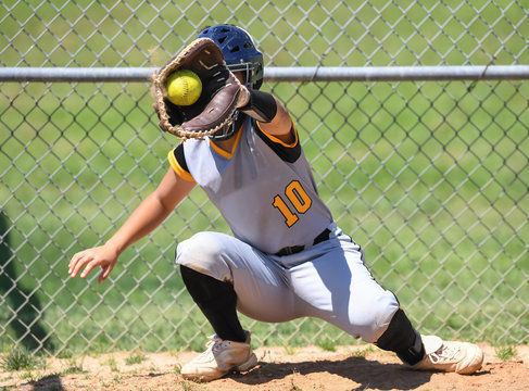 Young high school softball players in action, making amazing plays, during a game - Powered by Adobe