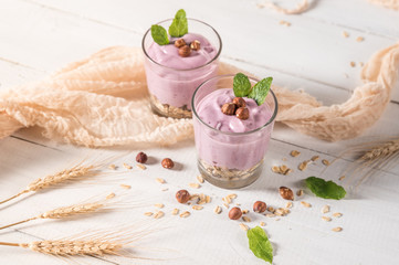 Healthy breakfast parfait with yogurt, granola and nuts in glass