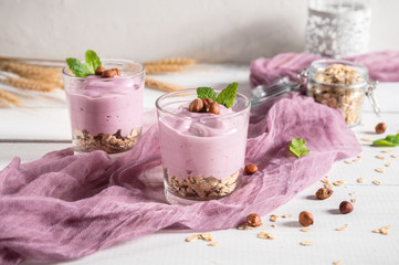 Obraz na płótnie Canvas Healthy breakfast parfait with yogurt, granola and nuts in glass