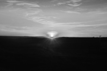 Fototapeta premium Beautiful sunset over the green field in the spring evening