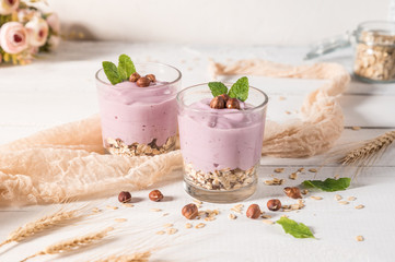 Healthy breakfast parfait with yogurt, granola and nuts in glass