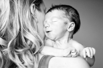 Newborn Baby Nuzzling Mother's Face