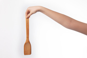 Wooden spatula in hand , isolated on white background