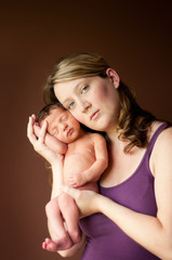 Newborn Baby Held in Loving Mother's Arms