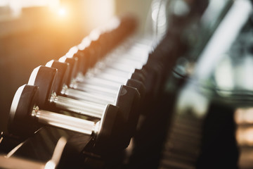Rows of dumbbells in the gym