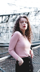 Beautiful girl on a background of a roller coaster - sunny day