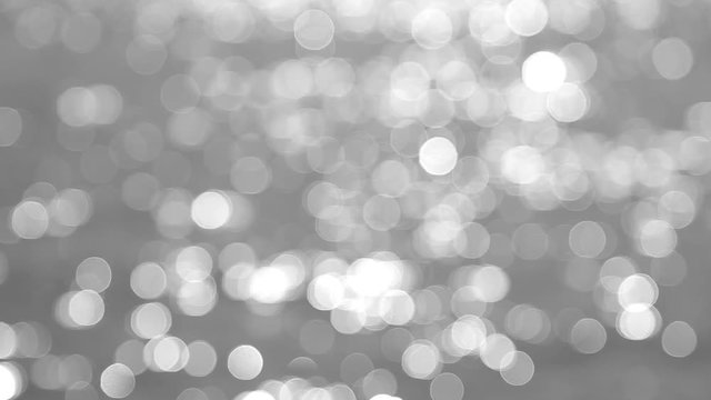 Blurry bokeh black and white video background.