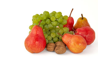 Fruit platter of ripe green walnuts grapes and red aromatic pears isolated on white